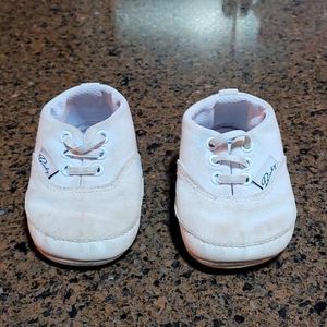 White baby girl or boy sneaker shoes.